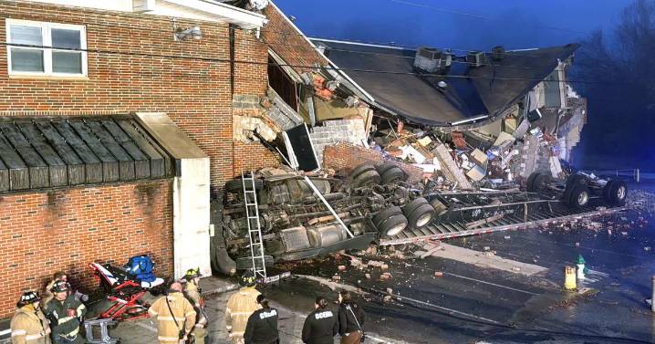 Tractor-trailer crashes into Cabell County business; driver freed after 2 hours