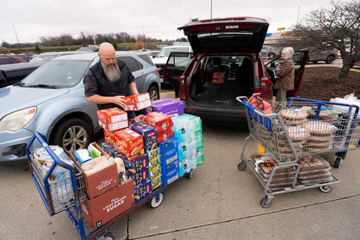 A cafeteria worker prepares a Thanksgiving meal to feed hundreds