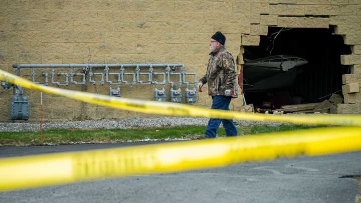 Vehicle goes through Akron Fulton Airport fence into concrete hangar
