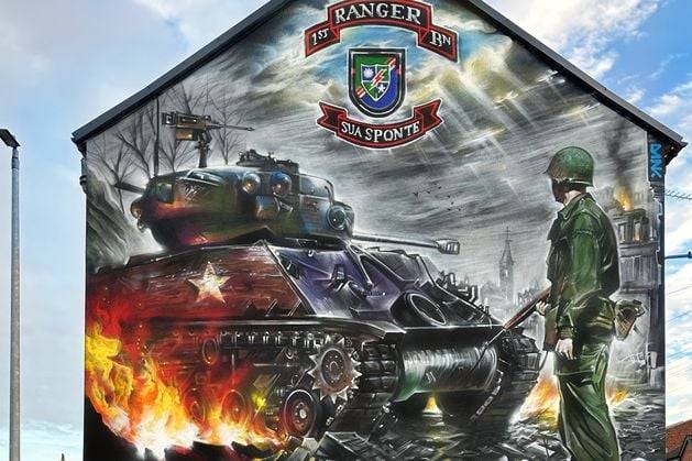 Mural artist defends new work in Carrickfergus after criticism over ‘aggressive depiction of horrors of war’