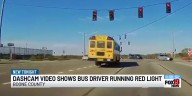 Dash cam shows bus driver running red light
