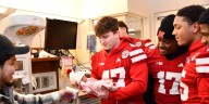 Husker football players bring holiday cheer to hospital patients, families