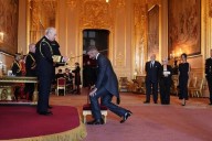 Bend a knee like Beckham: Soccer star is knighted by King Charles III