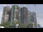 At least 94 dead as Hong Kong firefighters battle burning towers for a second day