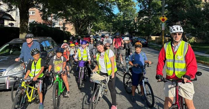 From a few to more than 350, children and parents ride together to school as a 'bike bus'