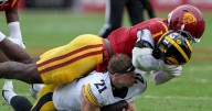 Commentary: USC keeps its playoff hopes alive with downpour of toughness against Iowa