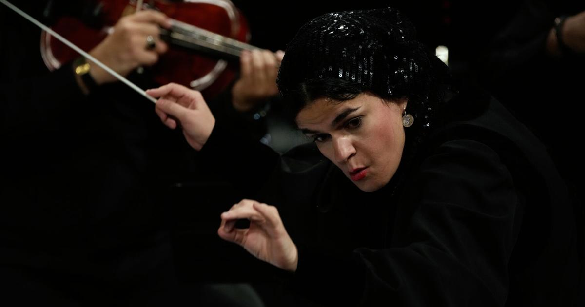 Photos of the first female conductor to lead a Tehran Symphony Orchestra performance