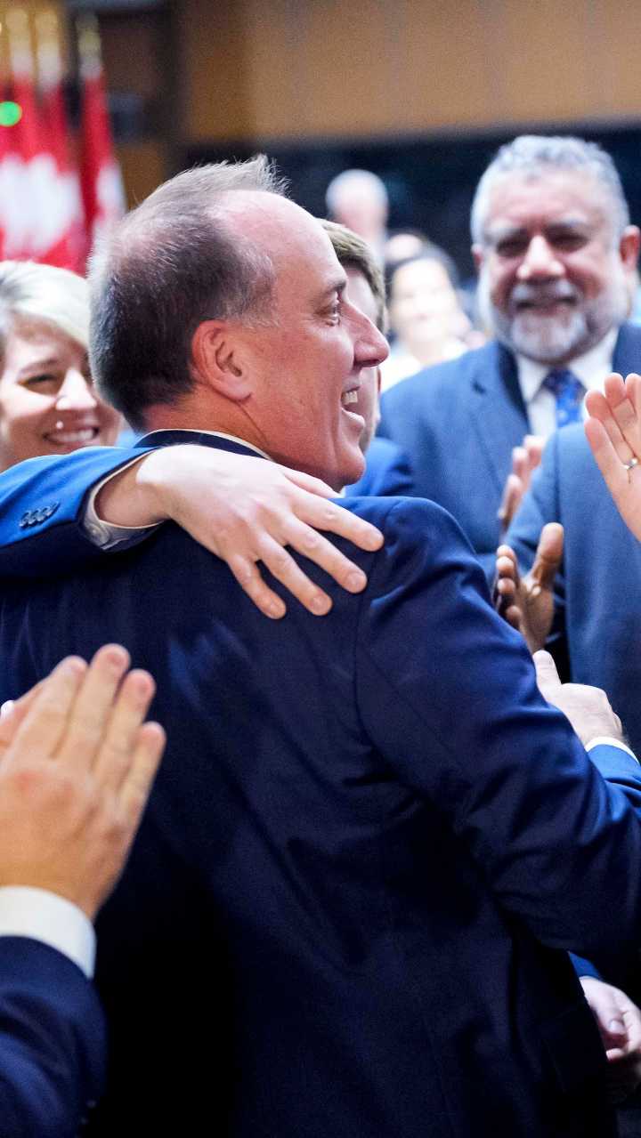 Floor-crossing MP greeted with cheers from Liberal caucus