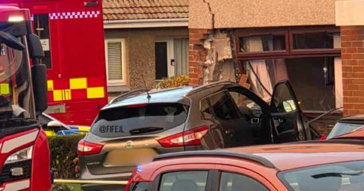 Pensioner rushed to hospital after 'car smashes into home' in Scots town