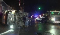 Tractor trailer filled with candy flips over in Lowell neighborhood