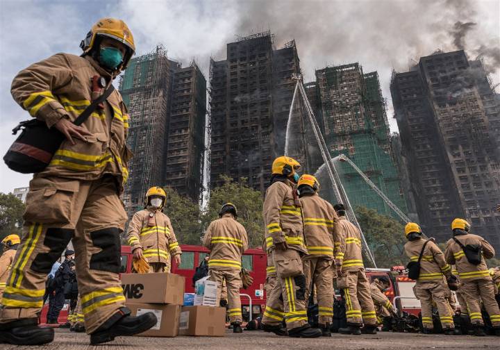 At least 83 dead as Hong Kong firefighters battle burning towers for a second day
