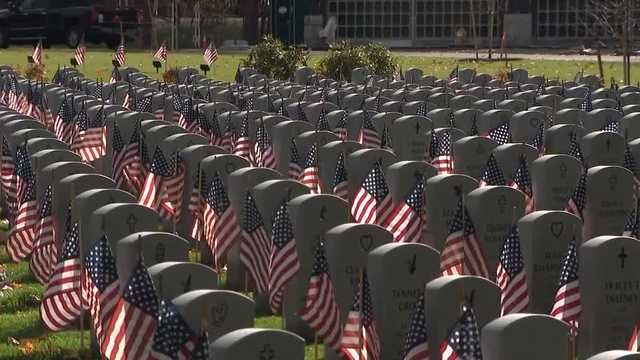 Hundreds of volunteers place flags on gravesites at New Hampshire State Veterans Cemetery
