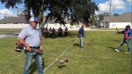 St. George and Central's mayors join Angelo's Landscape Group's weed eating contest