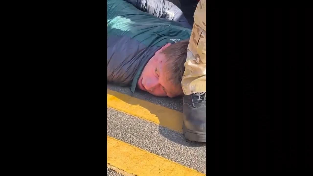 Video shows immigration agent punching restrained man after car collision turns into confrontation