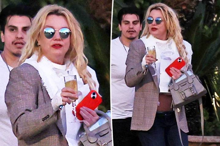 Britney Spears spotted walking to car with champagne flute as family remains concerned over erratic behavior