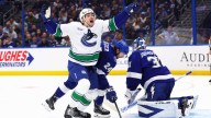 Hughes has 4 assists in return from injury, Canucks surge past Lightning