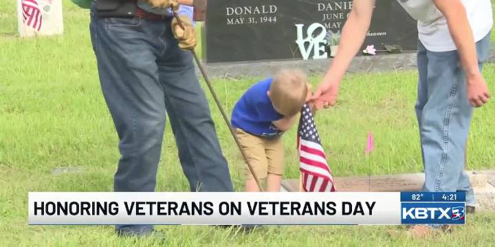 Wreaths Across America placing flags at graves for Veterans Day