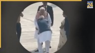 SHOCKING: RJD shares Viral Video of Nitish Kumar allegedly touching PM Modi’s feet at Patna Airport