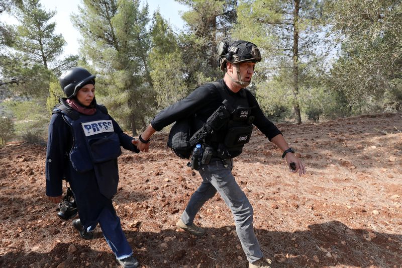 Israeli settlers attack Palestinians, journalists at West Bank olive harvest, witnesses say
