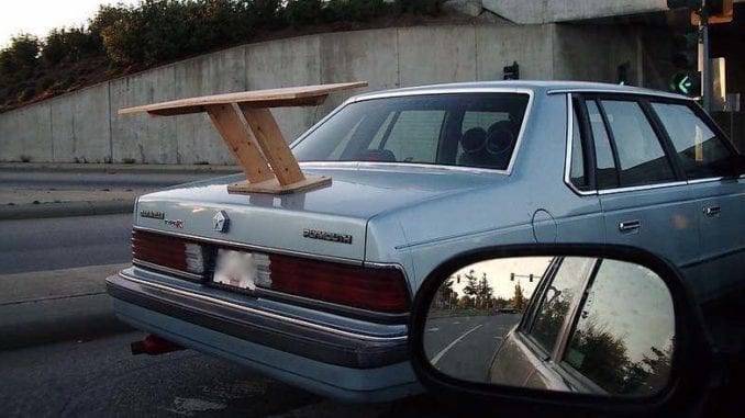 Area Resident Proves His Worth as a Man by Removing Muffler from Car