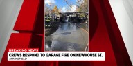 Firefighters rush to put out garage fire