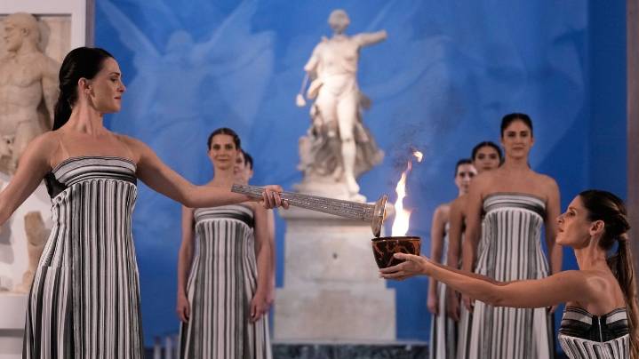 Under a cloud, the Olympic flame begins its journey to the Milan Cortina Winter Olympics
