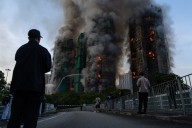 13 people killed in fire engulfing Hong Kong high-rise residential buildings, fire services say