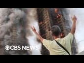 Distraught family members await answers as Hong Kong fire rages on and death toll climbs