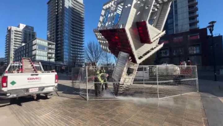 Upside-down church sculpture vandalized, burned in Calgary’s East Village