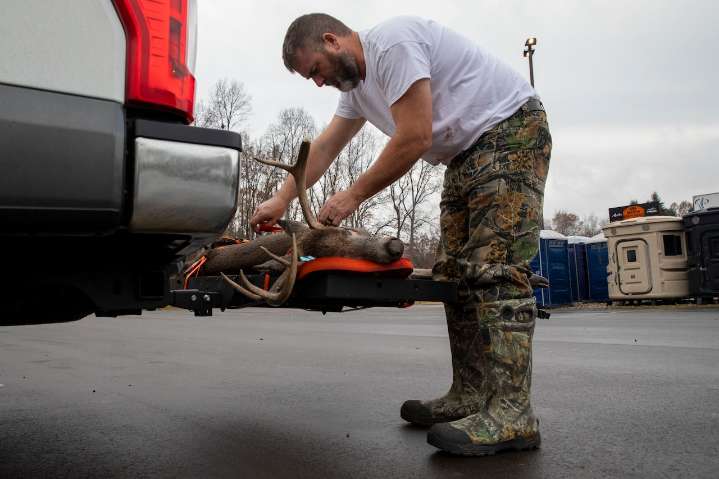 Hunters gather at Michigan buck pole on on opening day of firearm deer season