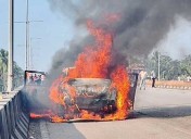 Byndoor: Moving car catches fire on flyover; passengers escape unhurt