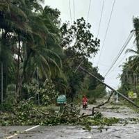 Floods strand people on roofs as typhoon pounds Philippines