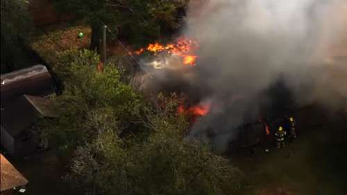 SkyEye shows crews fighting heavy fire burning at home on Winding Creek Way in southeast Houston