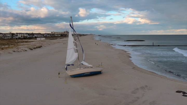 Stranded sailboat on Jersey Shore beach causing safety concerns