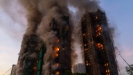 Fire rages through bamboo scaffolding at Hong Kong high-rise residential complex, killing 4