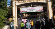 Multiple explosions shake a mosque in an Indonesian high school, injuring dozens