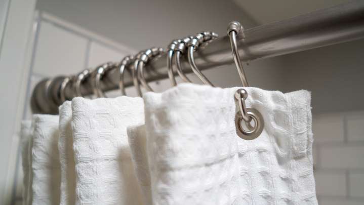 7 Shower Curtain Materials To Try (& The Best Way To Clean Them)