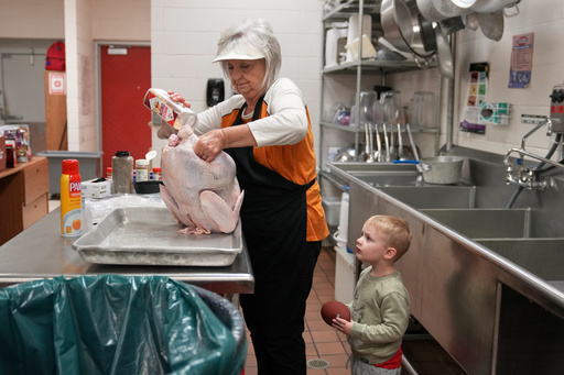 A cafeteria worker prepares a Thanksgiving meal to feed hundreds