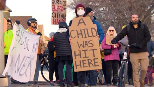 Winnipeggers rally at intersection where boy was hit by car while crossing street on bike
