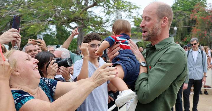 Prince William cuddles babies and takes selfies as he's mobbed by screaming fans