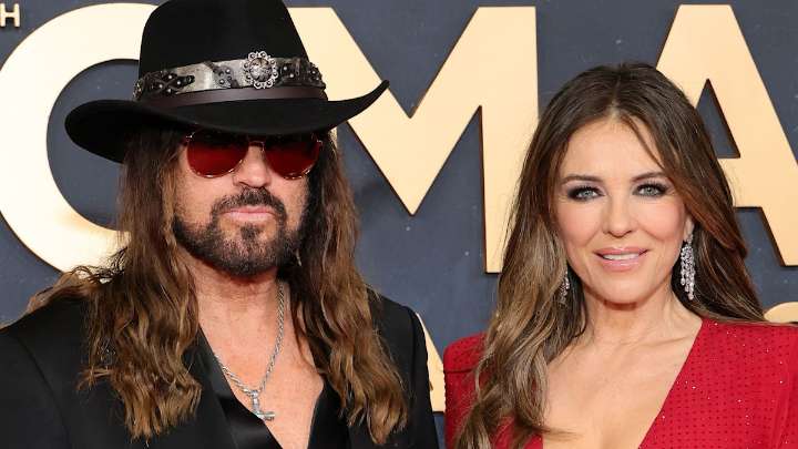 Elizabeth Hurley turns heads in dangerously low dress alongside Billy Ray Cyrus for CMA Awards debut