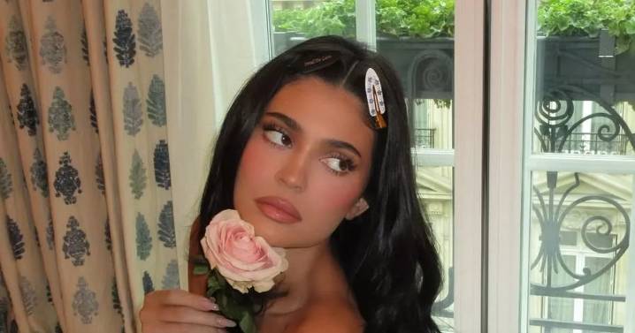 Kylie Jenner strips naked in bed and kisses pink rose in steamy display