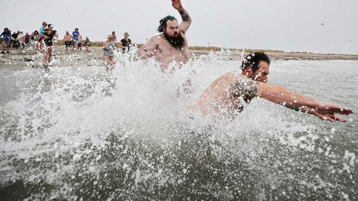 Plunge of the Faithful participants dive into cold Westport waters