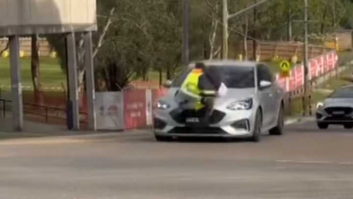 Man clings to car bonnet during Sydney road rage incident