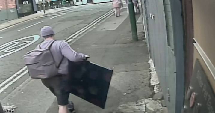 Burglar caught red-handed carrying huge stolen TV down street in broad daylight