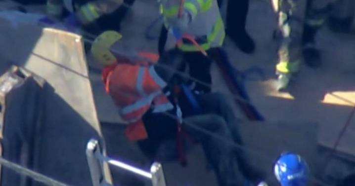 Video shows moment construction worker lifted to safety after trench collapse