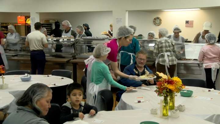 Families of volunteers help the People's City Mission serve up to 700 meals for Thanksgiving Day