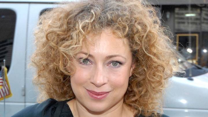 Alex Kingston looks radiant in olive green ruffled wedding dress for italian wedding