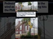 Pedestrian bridge swings in the wind as Typhoon Fung-wong hits in the Philippines