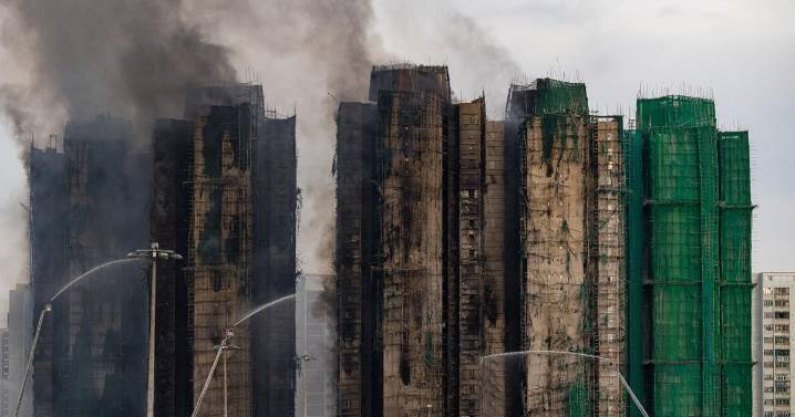 At least 94 dead as Hong Kong firefighters battle burning towers for a second day